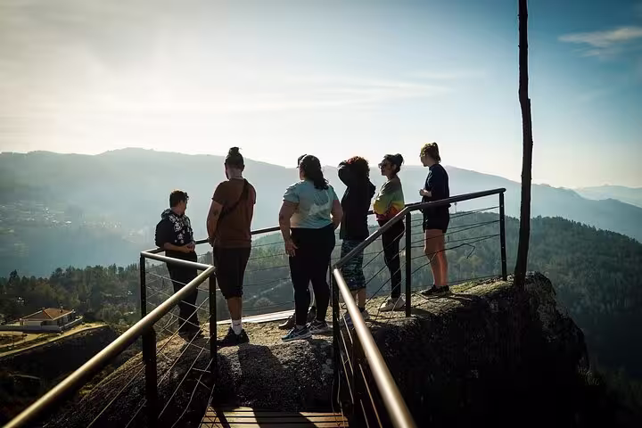 Group of tourists enjoying scenic mountain views from a viewing platform in Peneda Geres National Park.