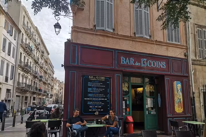 Outdoor tables at Bar des 13 Coins in Marseille, a popular pre-game stop on a guided pétanque experience
