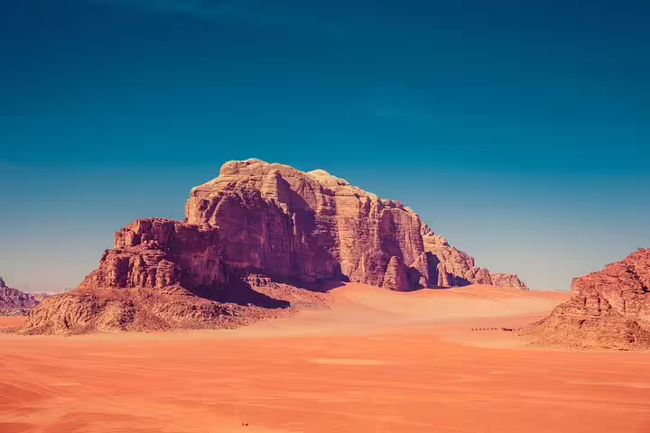 Wadi Rum red sand dunes and sandstone mountain scenery on Petra tour from Taba by ferry boat, Jordan