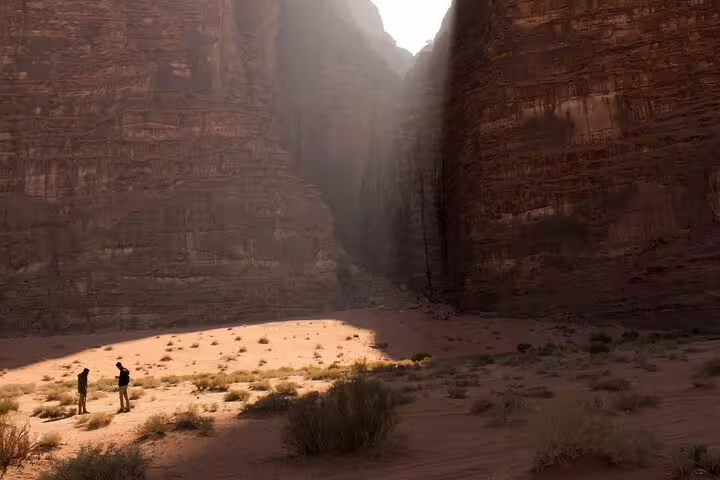 Travelers in Wadi Rum canyon desert on Petra tour from Taba by ferry boat, Jordan day trip adventure
