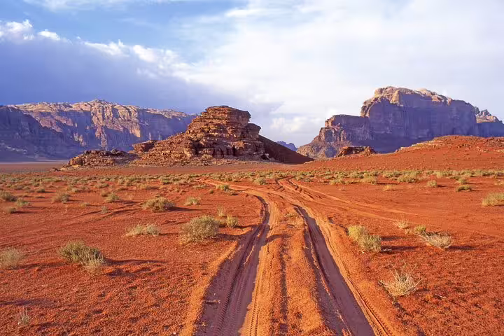 Wadi Rum red desert tracks and sandstone mountains, scenic stop on Petra tour from Taba by ferry boat