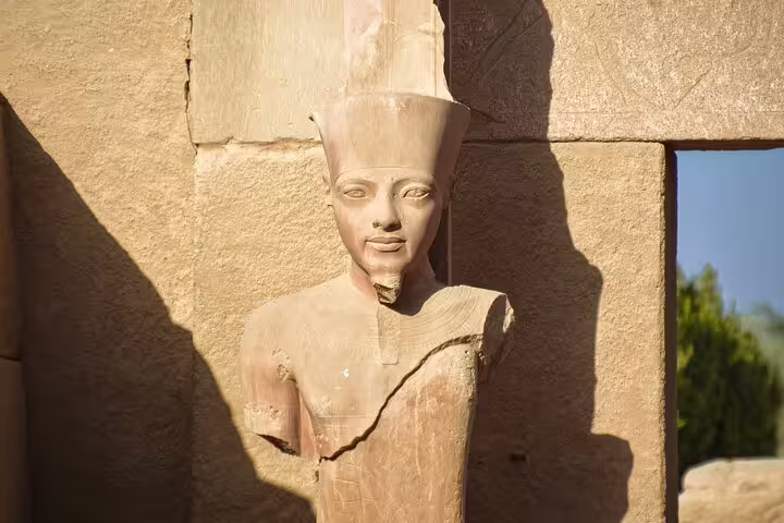 Ancient pharaoh statue in warm light at Dendera Temple, Egypt, on Dendera and Medinet Habu tour