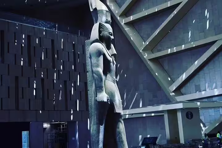 Colossal pharaoh statue inside the Grand Egyptian Museum atrium on a private guided visit in Giza