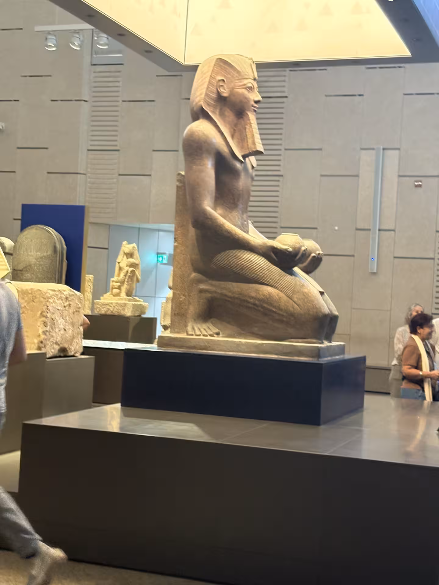 Seated pharaoh statue exhibit inside the Grand Egyptian Museum, part of private all-inclusive GEM tour