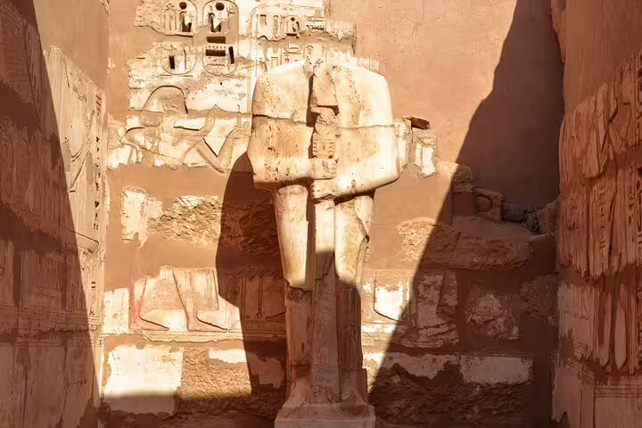Colossal pharaoh statue at Medinet Habu Temple, Luxor, featured on the Dendera and Medinet Habu tour