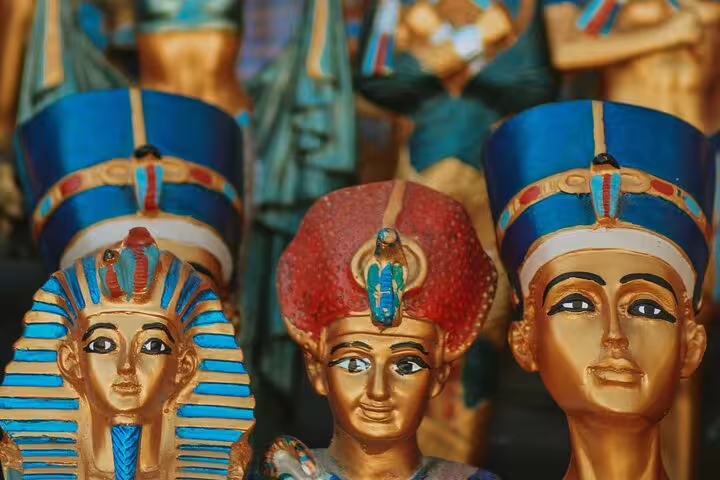 Colorful pharaoh statues and Egyptian souvenirs at a Cairo bazaar stop on a tuk tuk tour in Egypt