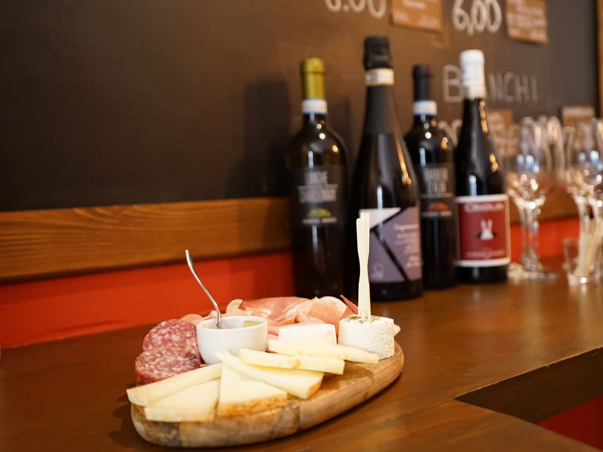 Piedmont wine tasting in Turin city center with local cheese and salumi board on a wine bar counter