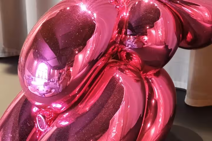 Shiny pink contemporary sculpture at Château La Coste art walk, Provence wine elegance discovery tour