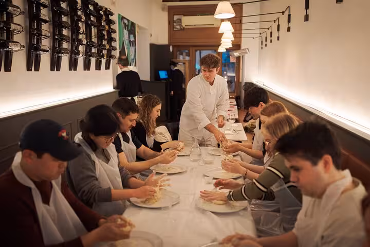 Participants learning to make pizza dough during a hands-on cooking class in Rome near Piazza Navona.