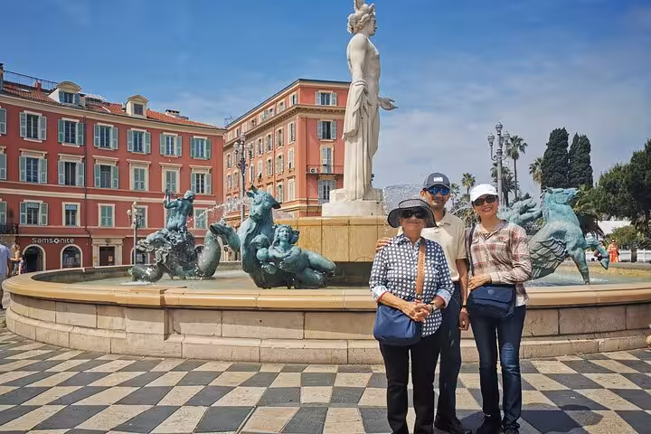 Travelers at Place Massena fountain in Nice, a highlight stop on a private day trip to Eze and Monaco