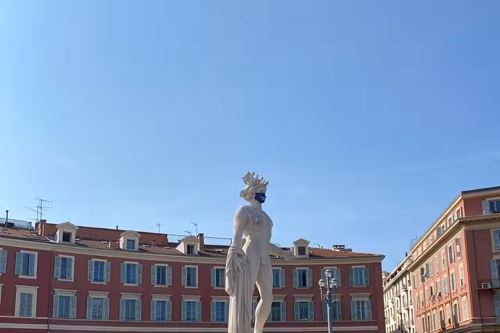 Statue at Place Massena in Nice with colorful facades, sightseeing on a private day trip to Eze and Monaco