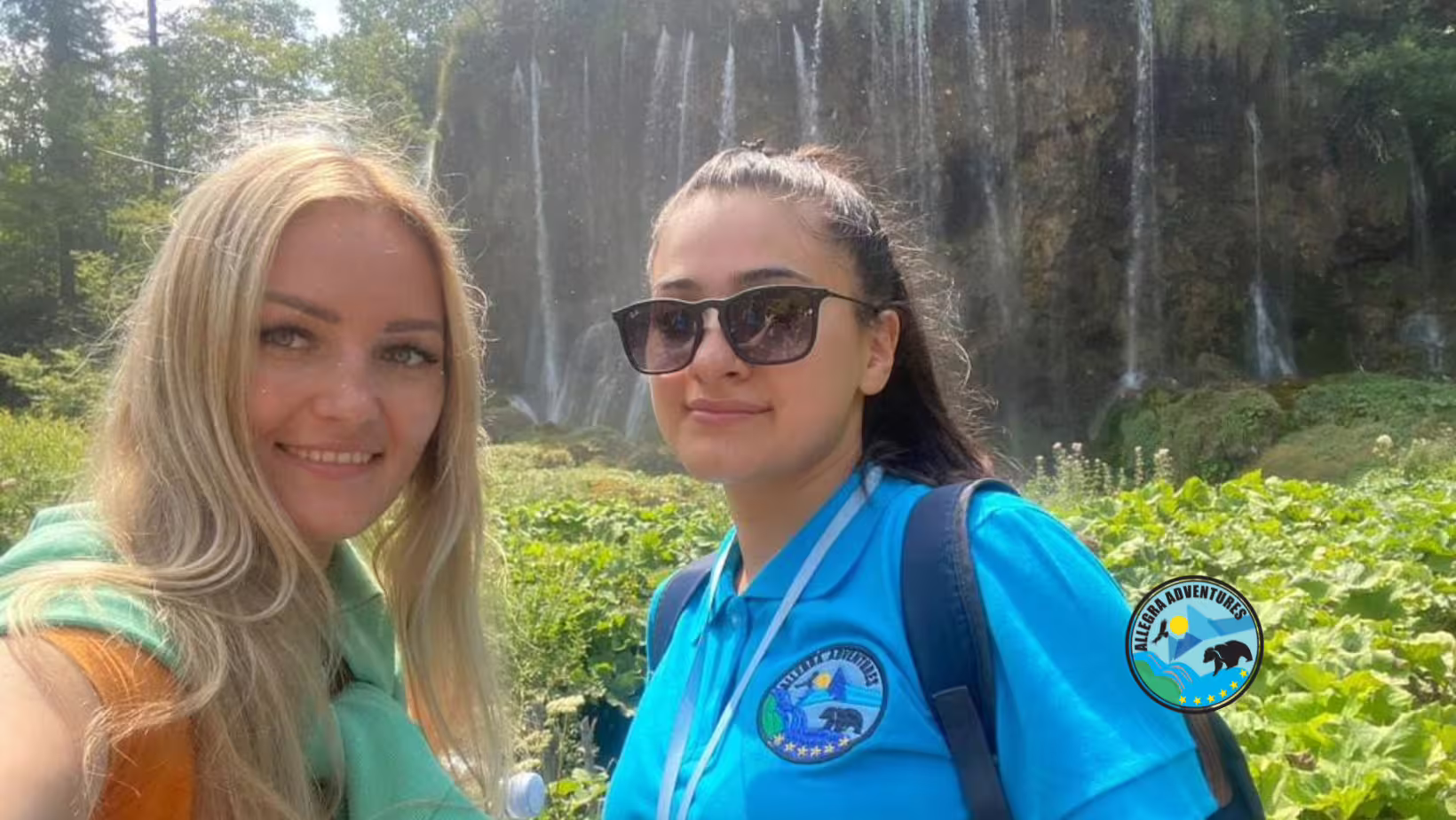 Travelers selfie at Plitvice Lakes waterfall on guided tour with secured entry tickets, train and boat ride