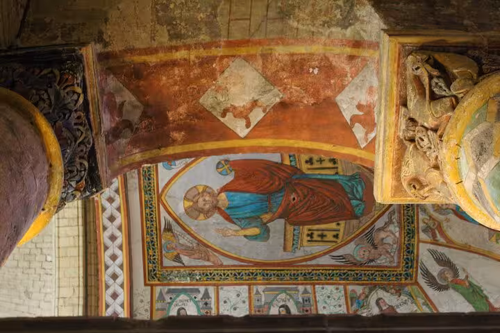 Vibrant medieval fresco depicting religious figures inside a historic Poitiers church, highlighting cultural heritage.
