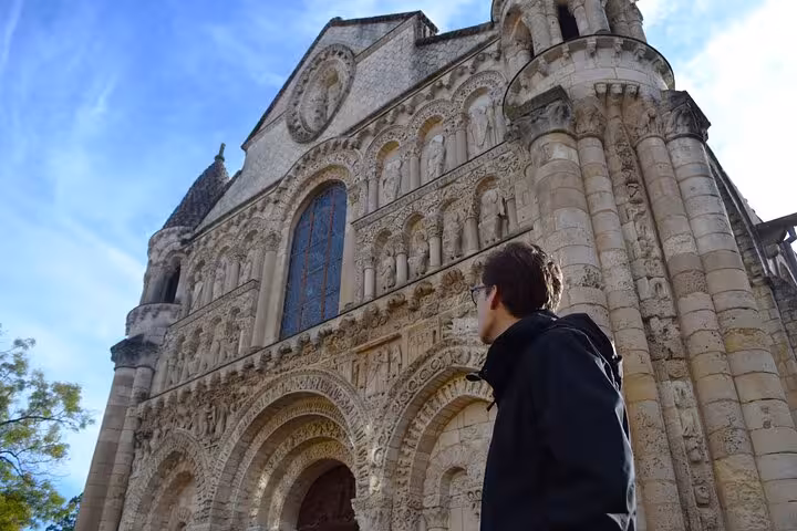 Explore the intricate facade of Église Notre-Dame la Grande in Poitiers on a captivating heritage walking tour.