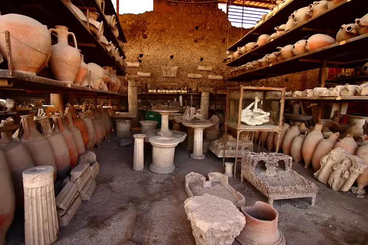 Shelves of amphorae, statues and artifacts in Pompeii storage area explored on a private archaeology-focused tour
