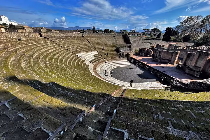 View of the ancient amphitheater in Pompeii, featured in a guided tour from Naples with skip-the-line entry.