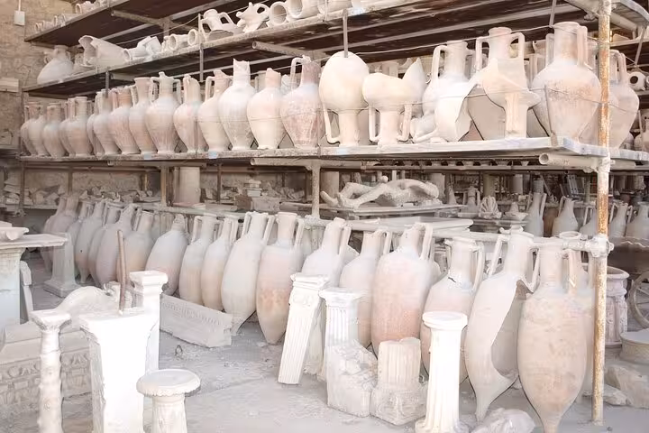 Ancient amphorae and artifacts displayed in Pompeii, enhancing the skip-the-line experience with historical insights.