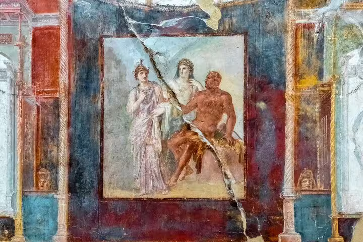 Ancient fresco of mythological figures in a Pompeii house, explored on a private guided archeology tour with expert insights
