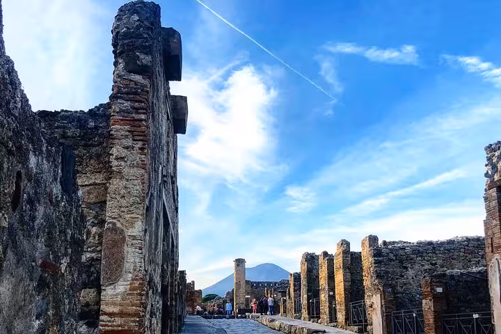 Explore ancient ruins with Mount Vesuvius backdrop on a guided small group Pompeii tour from Positano.