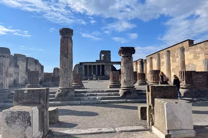 Explore ancient ruins with towering columns on the Pompeii guided tour from Positano, featuring skip-the-line access.