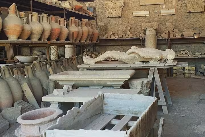 Discover preserved artifacts and plaster casts in a storeroom during the skip-the-line Pompeii guided tour.
