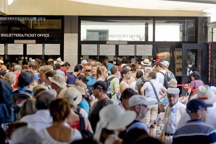 Visitors gather at the entrance of Pompeii, ready to explore the ancient ruins on a private guided tour.
