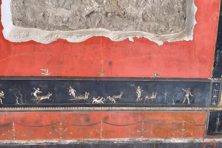 Detailed Roman fresco with mythological figures, seen on the Positano Pompeii tour with a wine tasting experience.