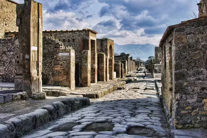 Cobbled Roman street and stone ruins of ancient Pompeii viewed on a private, personalized archaeology expert tour
