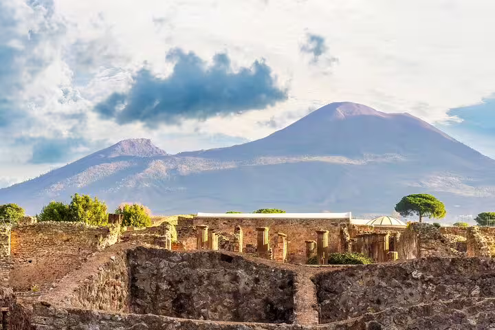Pompeii ruins with Mount Vesuvius backdrop on a private Naples day trip and vineyard wine tasting tour
