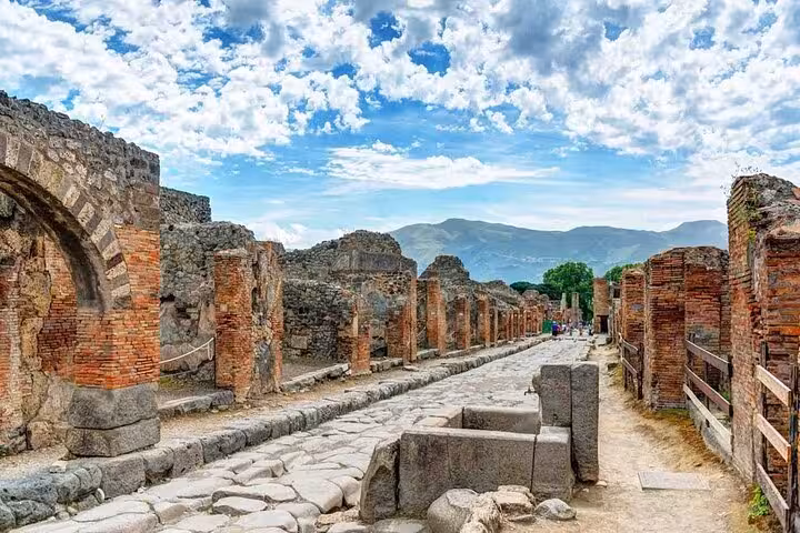 Explore the ancient ruins of Pompeii with a stunning view of Mount Vesuvius on a full-day tour from Positano.