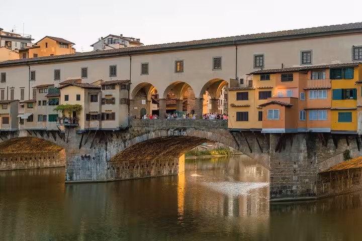 View of the Ponte Vecchio bridge in Florence, a highlight on the Accademia and Uffizi Small-group Tour.