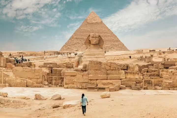 Visitor facing the Great Sphinx and Pyramid of Khafre at Giza, key stop on Port Said shore excursion
