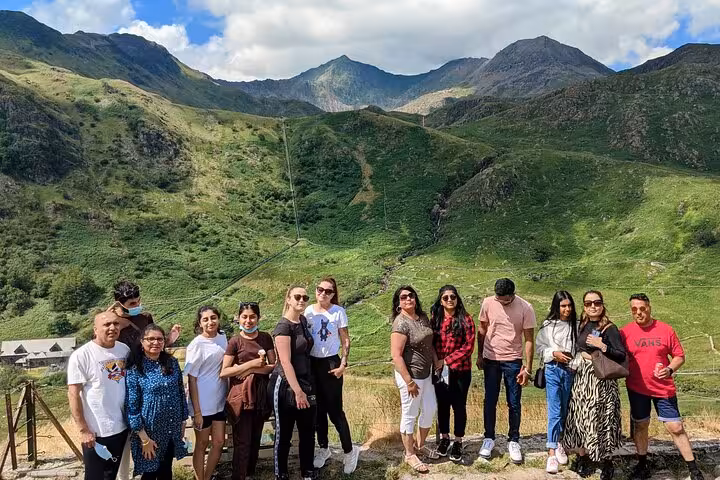 Tour group in Snowdonia National Park with green Welsh mountains, Portmeirion and castles day tour photo