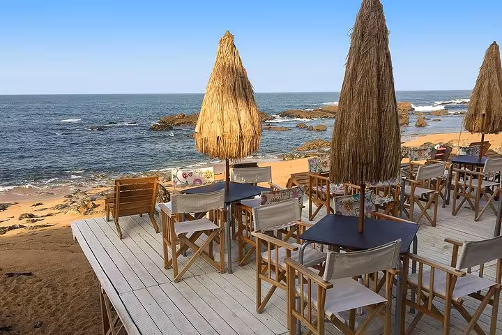 Charming beachside cafe with ocean views, ideal rest spot on the Porto small-group bike tour experience.