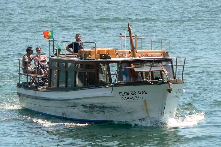 Small group enjoys a scenic boat ride on the Douro River, part of the Porto bike tour experience.
