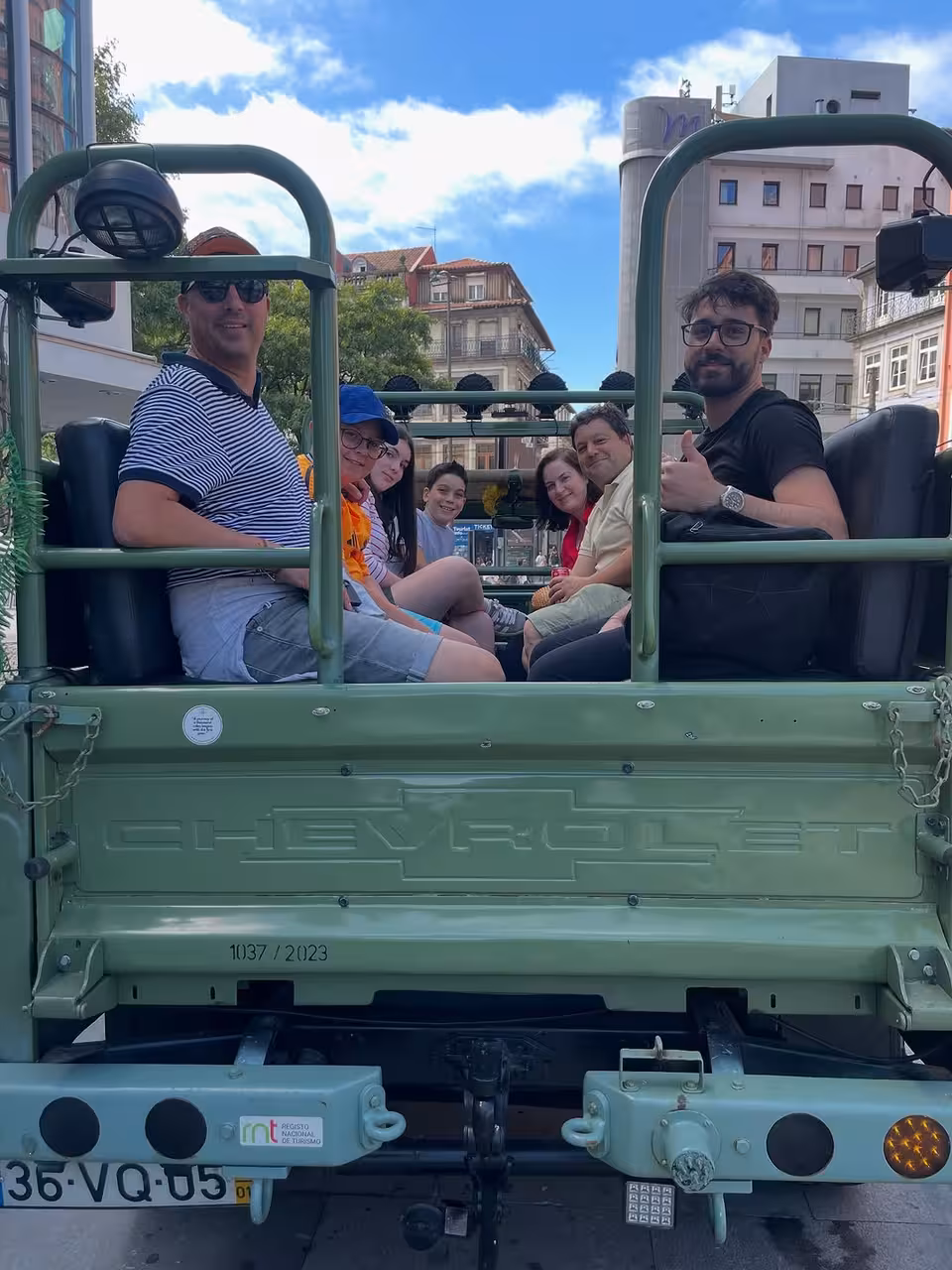 Group in vintage 4x4 jeep on Porto city tour, exploring historic landmarks and panoramic Douro views