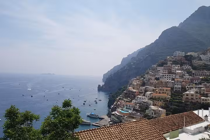 Positano cliffside houses and boats on the Tyrrhenian Sea, scenic stop on Amalfi Coast day tour from Rome