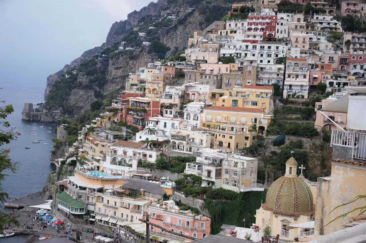 Panoramic view of Positano’s pastel cliffside villas and church dome overlooking the sea on an Amalfi Coast mini cruise