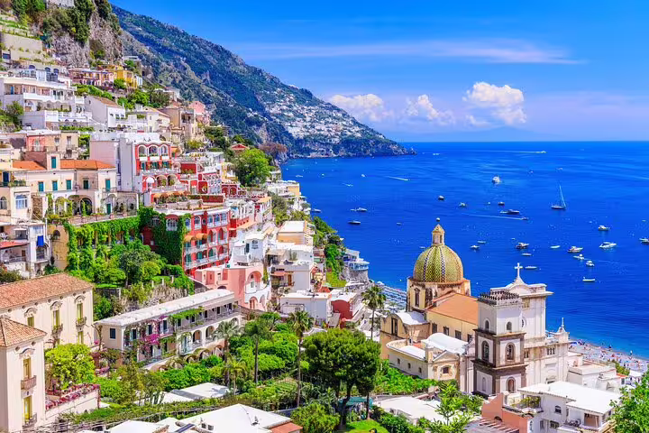 Positano cliffside houses and dome church on Amalfi Coast, scenic stop on private Naples day tour