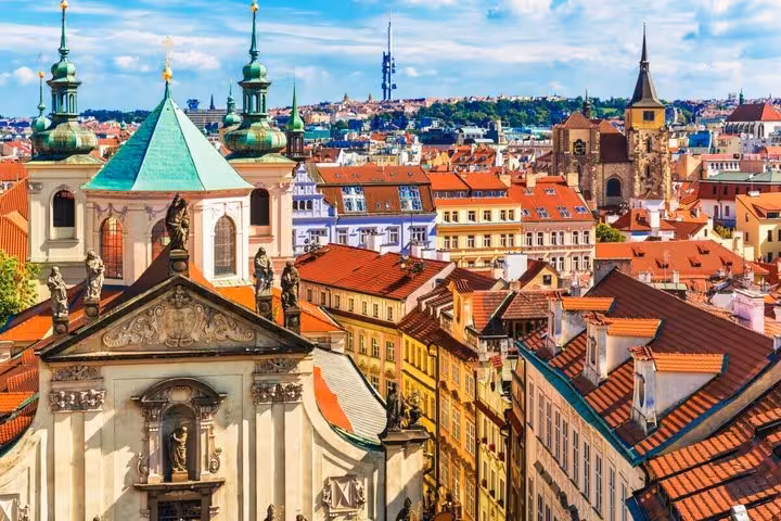 Prague Old Town red rooftops and church domes, scenic highlight on Vienna to Prague private transfer with stop