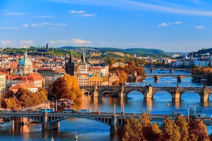 Prague skyline over Vltava River bridges, ideal stop on Vienna to Prague private transfer via Cesky Krumlov