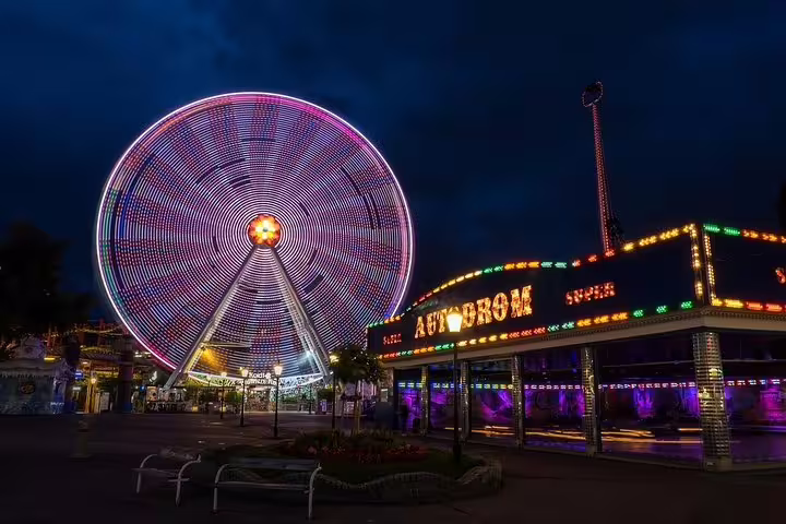 Vibrant Prater Ferris Wheel glowing against the night sky, offering a thrilling experience on a Vienna evening tour.