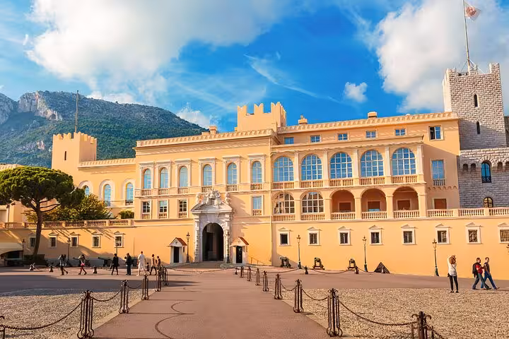 Explore the grandeur of the Prince's Palace in Monaco, surrounded by scenic mountains and vibrant architecture.