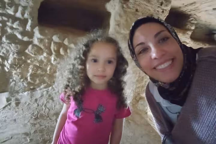 Visitor and child inside the Catacombs of Kom El Shoqafa on a private Alexandria day tour from Cairo
