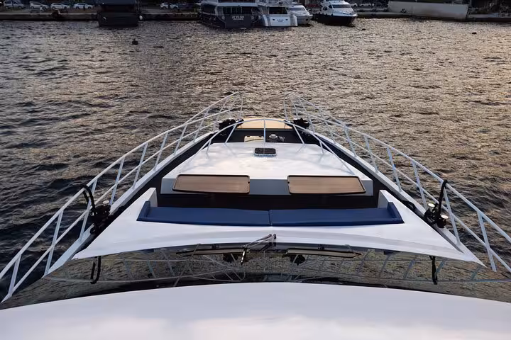 Bow view on private Bosphorus yacht cruise in Istanbul, cruising calm waters with marina ahead
