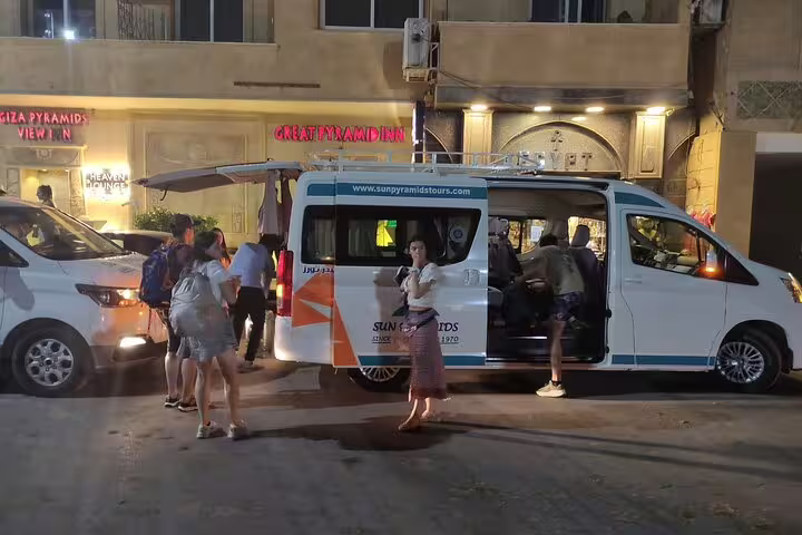 Private Cairo airport transfer minivan at night pickup with travelers boarding for hotel drop-off in downtown Cairo