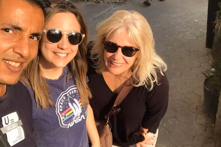 Happy travelers with private guide on Cairo tour to Grand Egyptian Museum, Citadel and Khan El Khalili