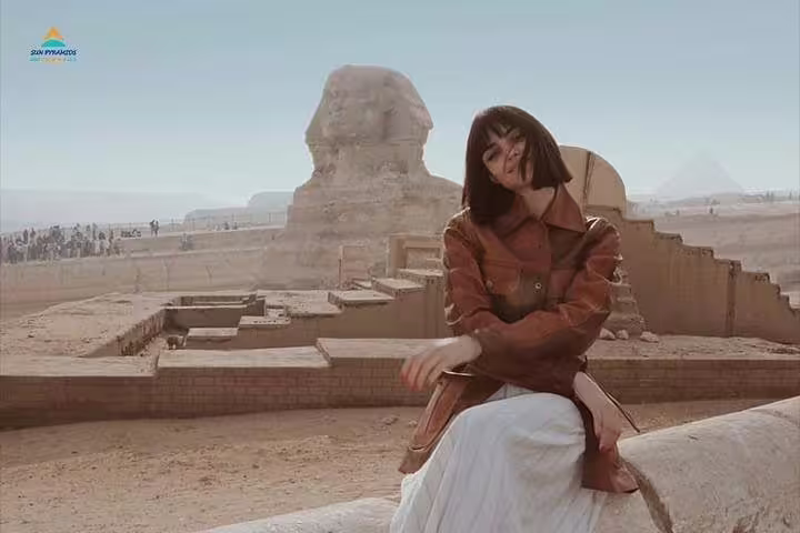 Traveler posing by the Great Sphinx of Giza on a private Cairo day trip from Hurghada by plane with guide