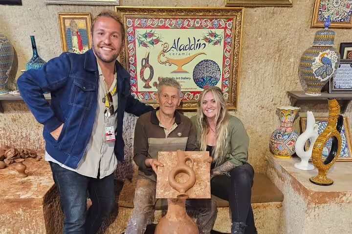 Travelers at Aladdin Ceramic Gallery, experiencing local pottery craft on a private Cappadocia tour from hotel and airport.