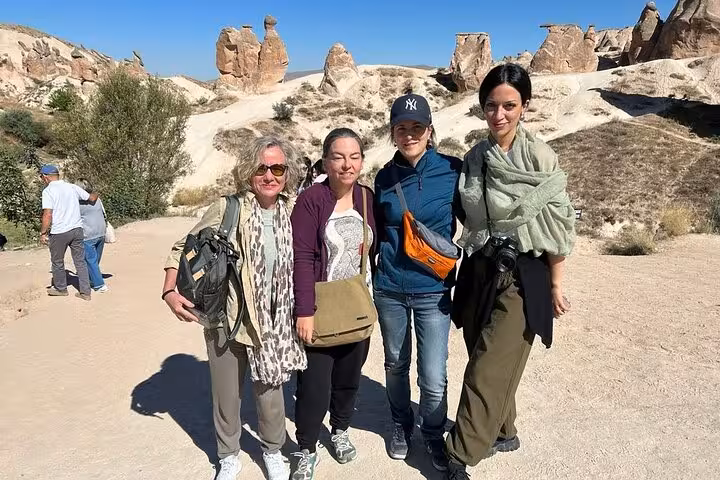 Guests on private Cappadocia tour with English-speaking guide exploring fairy chimneys, luxury vehicle day trip
